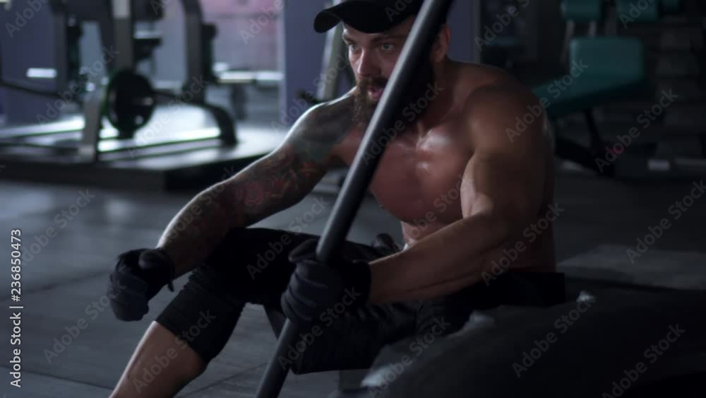 Muscular man taking a break after intense fitness workout Muscular man taking a break after intense fitness workout