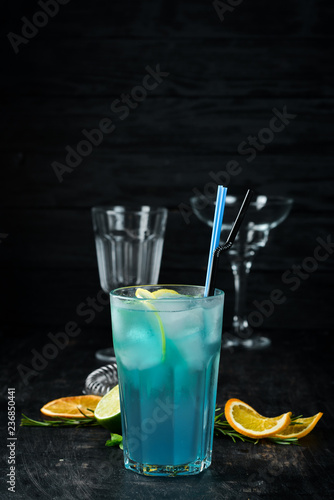 Alcoholic cocktail Blue Lagoon. Drinking On a wooden background. Top view.