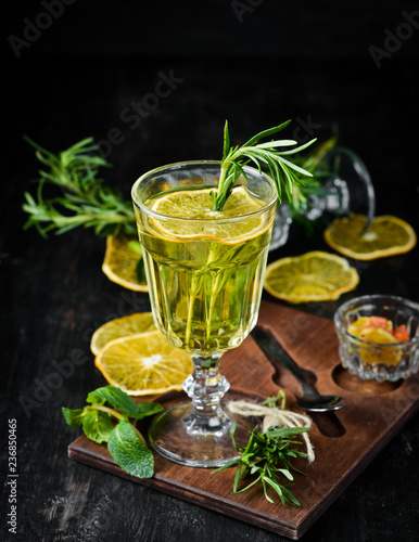 Hot white wine and rosemary cocktail. On a wooden background. Top view. Free copy space.