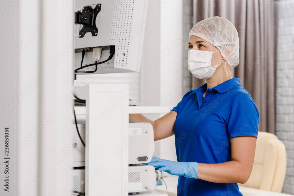 Naklejka premium Female operator of ultrasound scanning machine doing test for patient