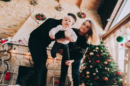 Fototapeta Naklejka Na Ścianę i Meble -  Young family in Christmas interior