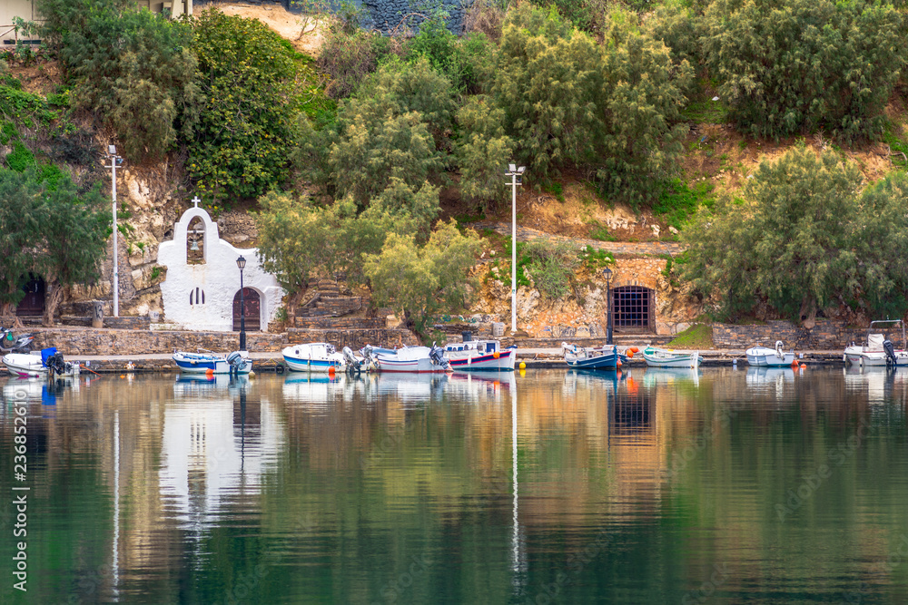 The lake Voulismeni in Agios Nikolaos, a picturesque coastal town with colorful buildings around the port in the eastern part of the island Crete, Greece The lake Voulismeni in Agios Nikolaos, a picturesque coastal town with colorful buildings around the port in the eastern part of the island Crete, Greece