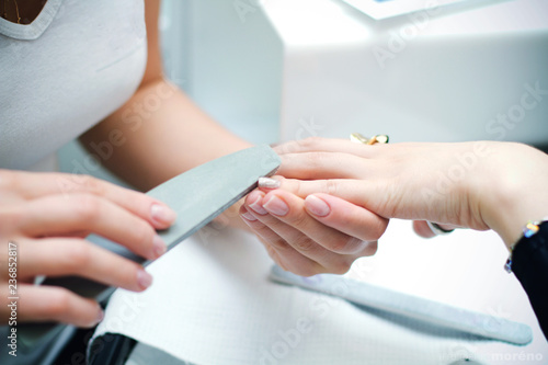 Nails manicure with file. Woman beautiful nail care. after filling.