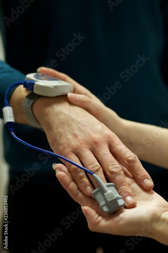 A nurse uses a pulse oximeter to monitor a patients oxygen saturation