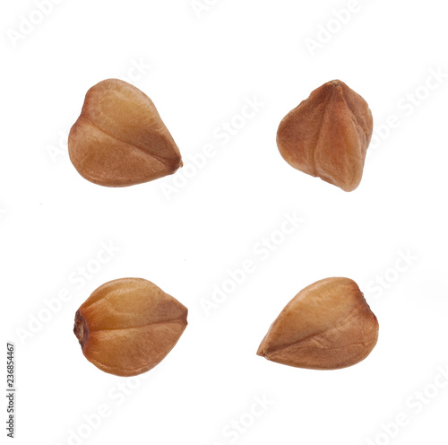 Four grains of buckwheat isolated on white background.