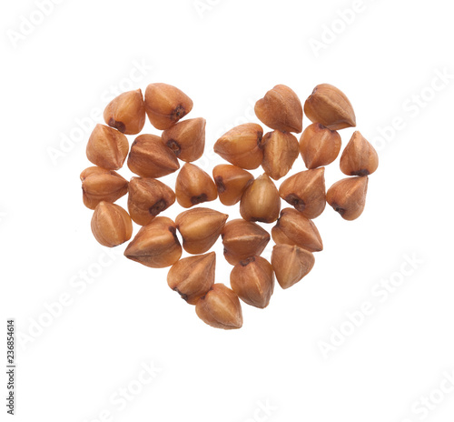 Grain buckwheat closeup isolated on white background. In the shape of a heart.