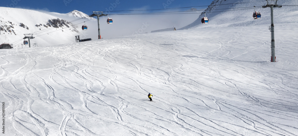 Skiers downhill on ski slope