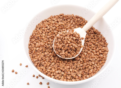 Buckwheat in bowl closeup isolated on white background.