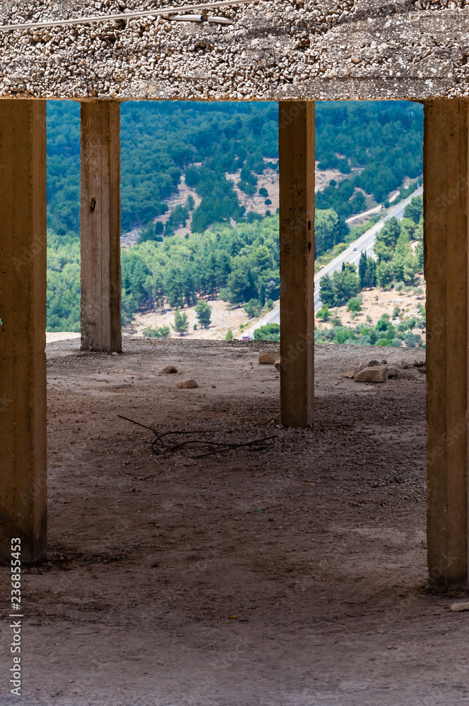 Concrete frame columns of the abandoned building in Old Town of Sefed with panorama to the North nature of Israel Concrete frame columns of the abandoned building in Old Town of Sefed with panorama to the North nature of Israel