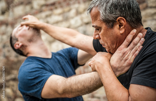 Kapap instructor demonstrates street fighting self defense techniques. Martial arts