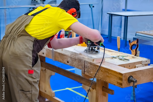 A carpenter. Milling machin...