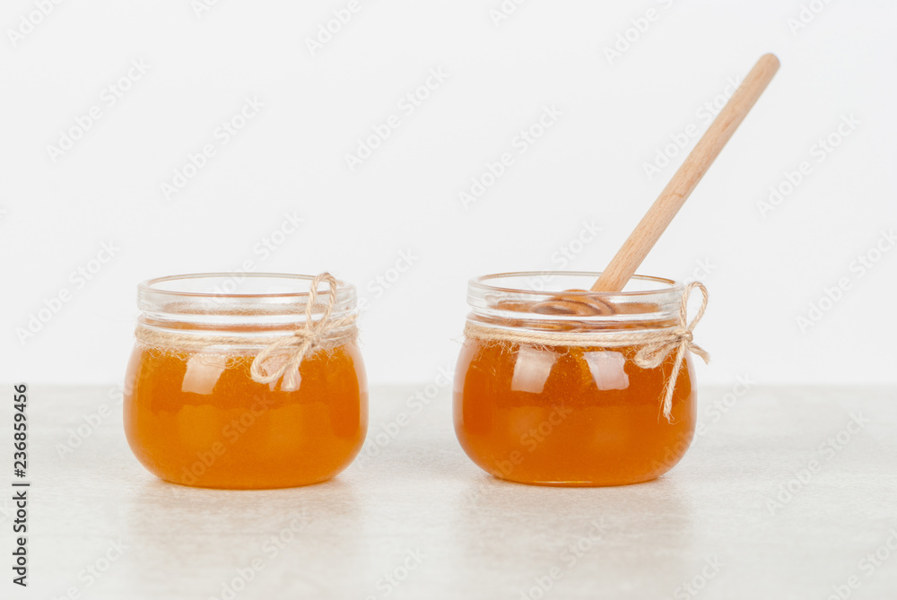 honey in jars on white table honey in jars on white table