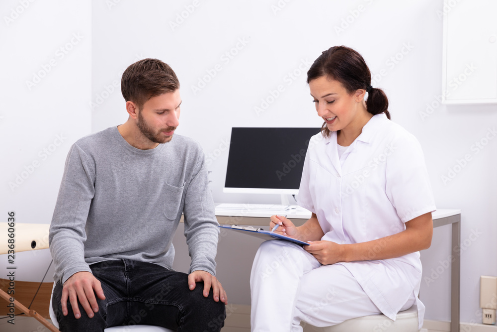 Doctor Giving Prescription To Male Patient Doctor Giving Prescription To Male Patient