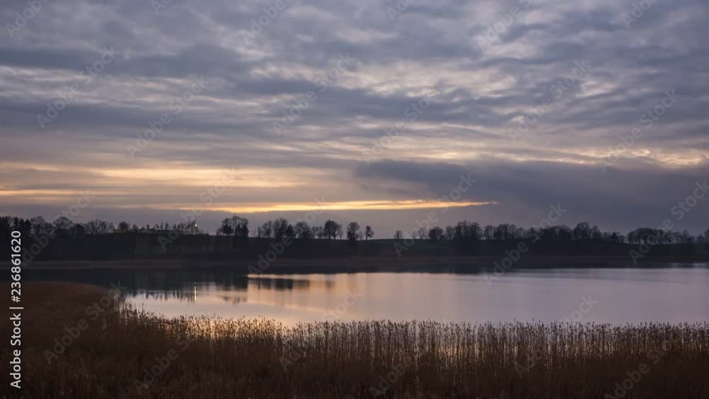 Sunset sky over calm lake, time-lapse video. Sunset sky over calm lake, time-lapse video.