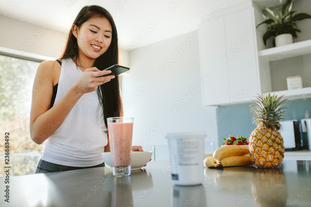 Woman taking picture of her nutritious breakfast Woman taking picture of her nutritious breakfast