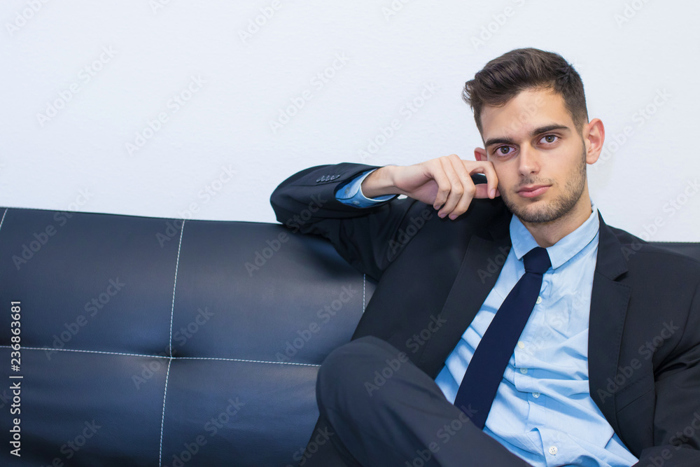 businessman smiling sitting on the couch businessman smiling sitting on the couch