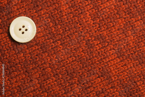 Button on textile background. copy space