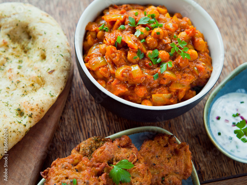 Chickpea Tomato Vegetarian, Vegan, Plant Based Curry  -  Chana Masala with Naan Bread. Chana masala, also known as channay, chole masala, chole or chholay, is a dish originating from the India. photo