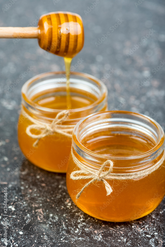 honey in jars on black table