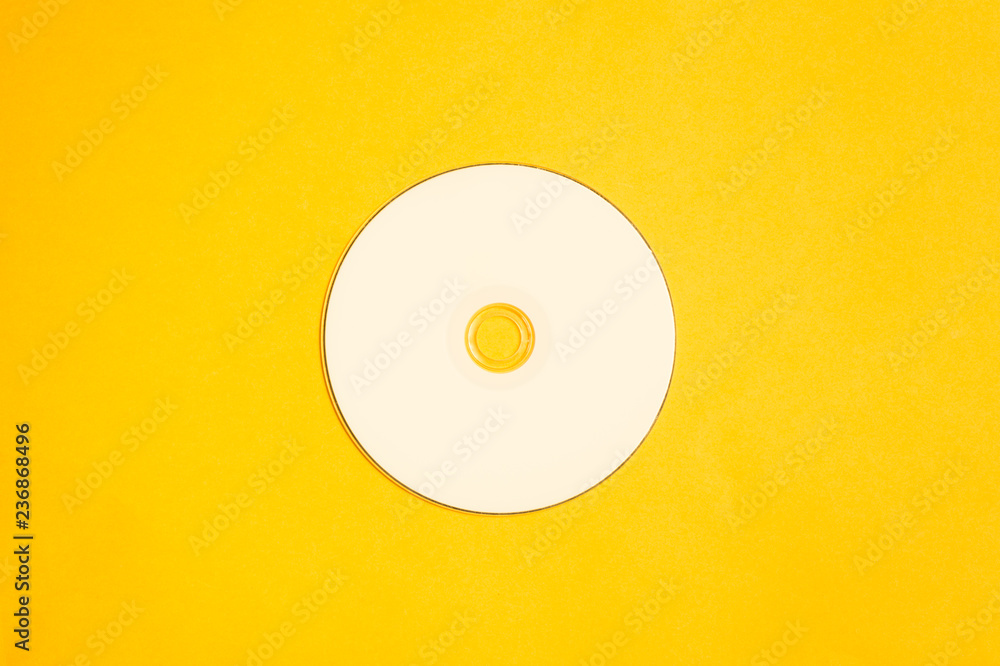 Compact disc on a yellow background. copy space Compact disc on a yellow background. copy space