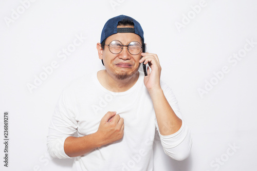 Young Man Getting Bad News on Phone, Shocked and Crying © airdone