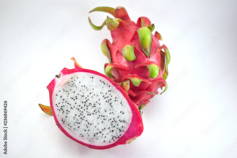 Exotic ripe white Pitaya or Dragon fruit. Red Pitahaya tropical fruit cut in half on white background Exotic ripe white Pitaya or Dragon fruit. Red Pitahaya tropical fruit cut in half on white background