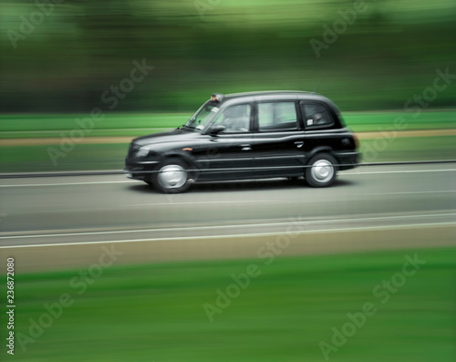 London black taxi cab speeding along road © Cameo