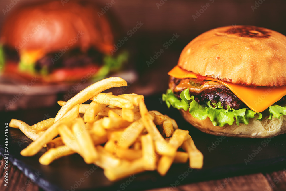 burger with french fries on wooden background