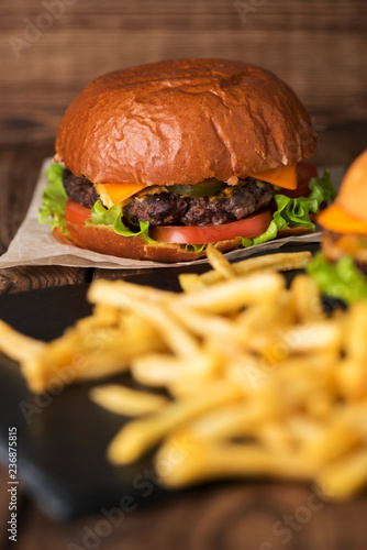 burger with french fries on wooden background