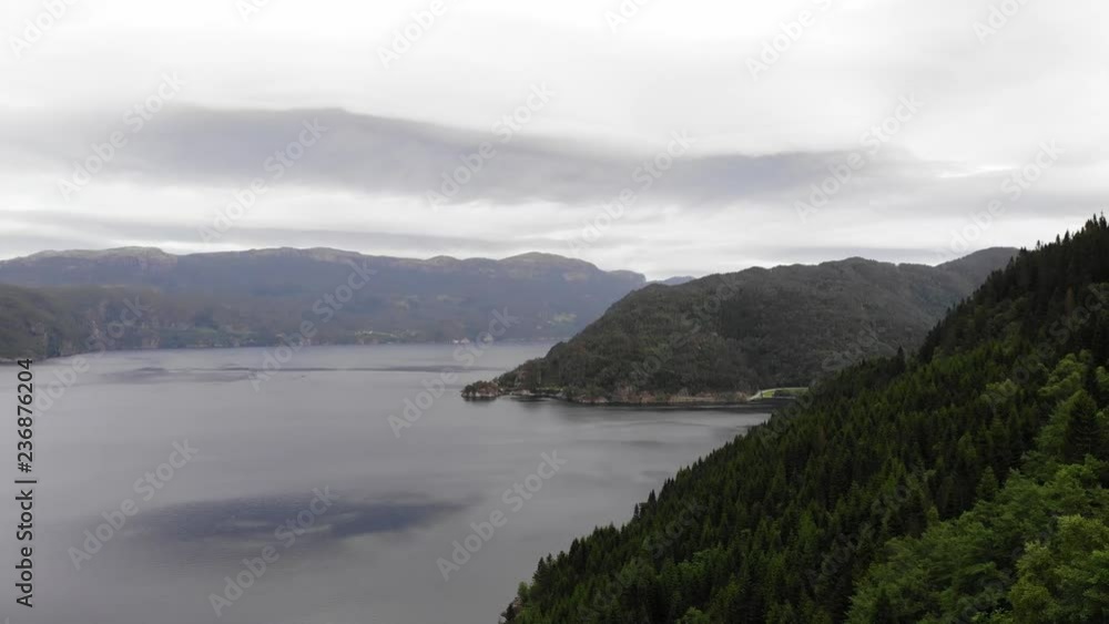 Aerial view. Norwegian landscape. Mountains hills and fjord Saudafjord, evening time, overcast weather. National tourist Ryfylke route Aerial view. Norwegian landscape. Mountains hills and fjord Saudafjord, evening time, overcast weather. National tourist Ryfylke route