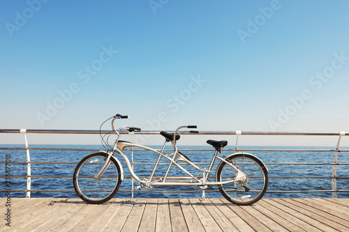 Tandem bike near sea on sunny day
