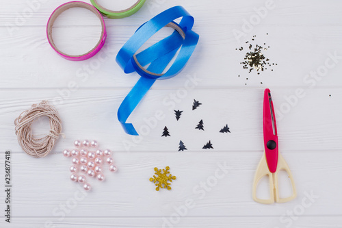 Beads and tools for Christmas DIY. Christmas wrapping tools arrangement. Childrens DIY concept.