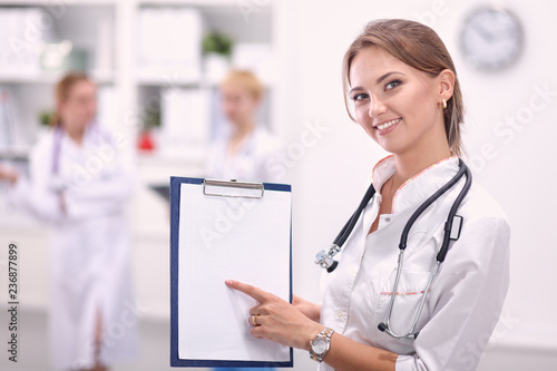 Portrait of woman doctor standing at hospital