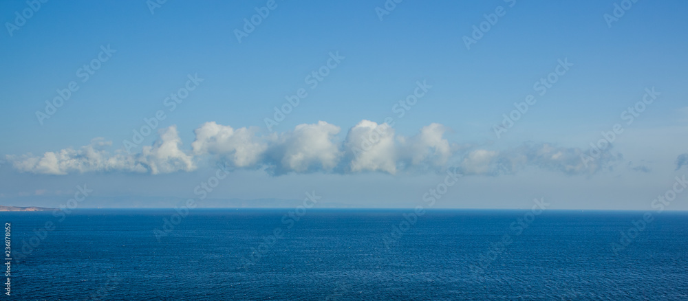 Fototapeta premium sea water surface to horizon line nature landscape panorama view with interesting shape of cloud in the sky similar to Rorschach test spot wallpaper concept, copy space