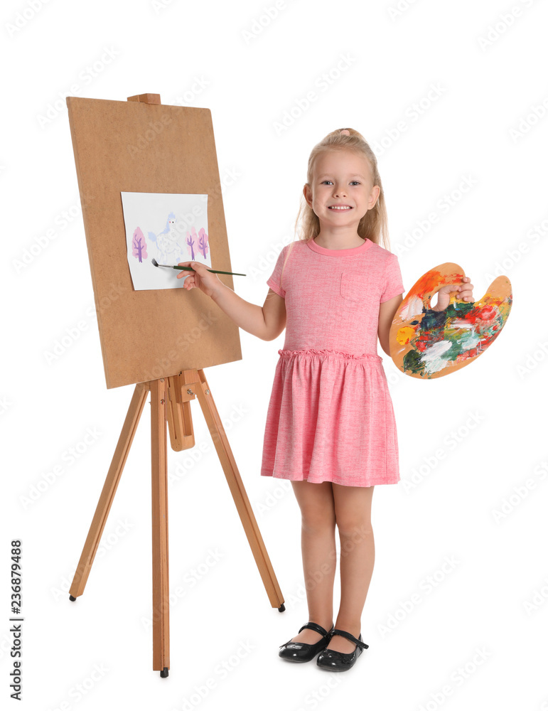 Fototapeta premium Child painting picture on easel against white background