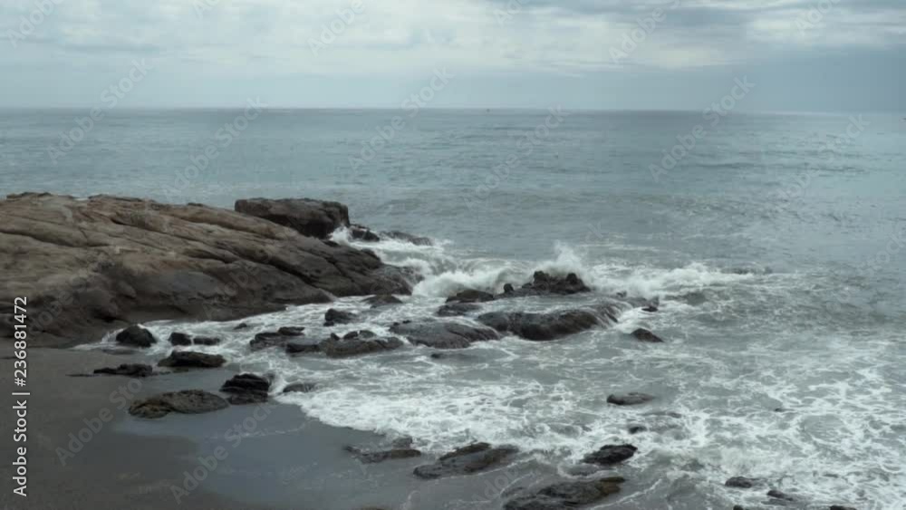 Slow Motion Sea Waves crashing on Islet and sandy shore Slow Motion Sea Waves crashing on Islet and sandy shore