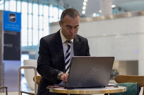 Business man working with laptop at the airport