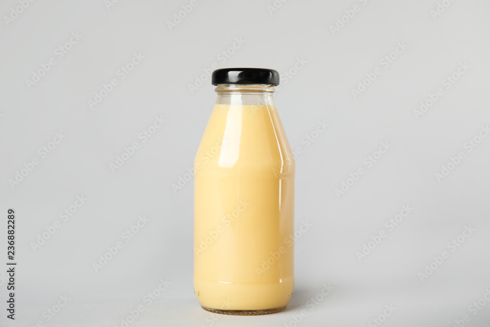 One bottle with tasty drink on color background One bottle with tasty drink on color background