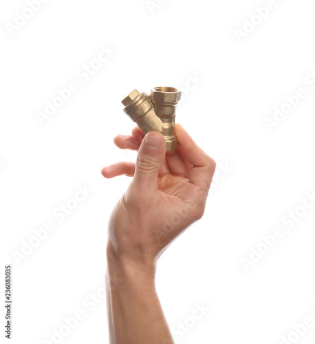 Male plumber holding pipe fitting on white background, closeup