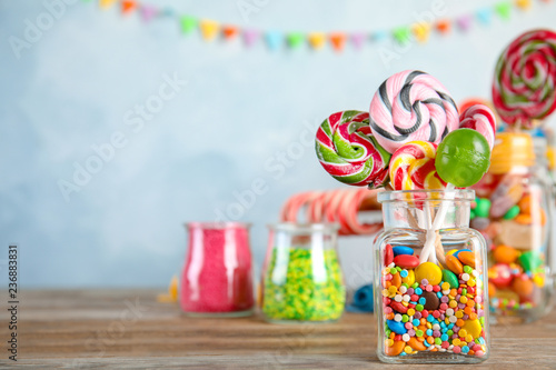 Composition with many different candies on table. Space for text