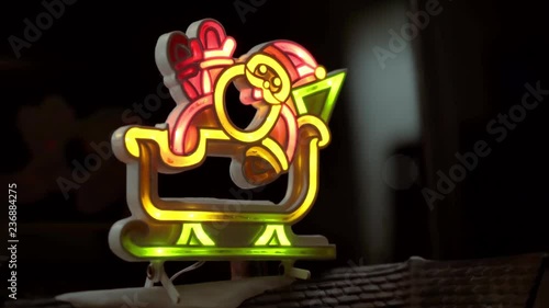 Light up santa on a miniature Christmas village roof