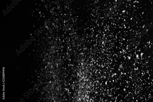 Snow flakes falling on black background. Winter weather