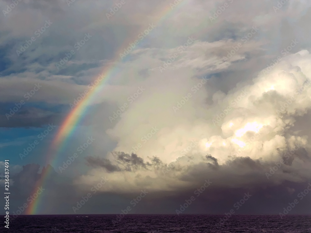 rainbow over sea clouds