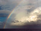 rainbow over sea clouds