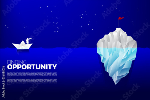 Silhouette of businessman with telescope on paper ship looking to flag on iceberg. Business Concept of finding opportunity and vision mission.