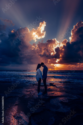 Couple in love at sunset by the sea