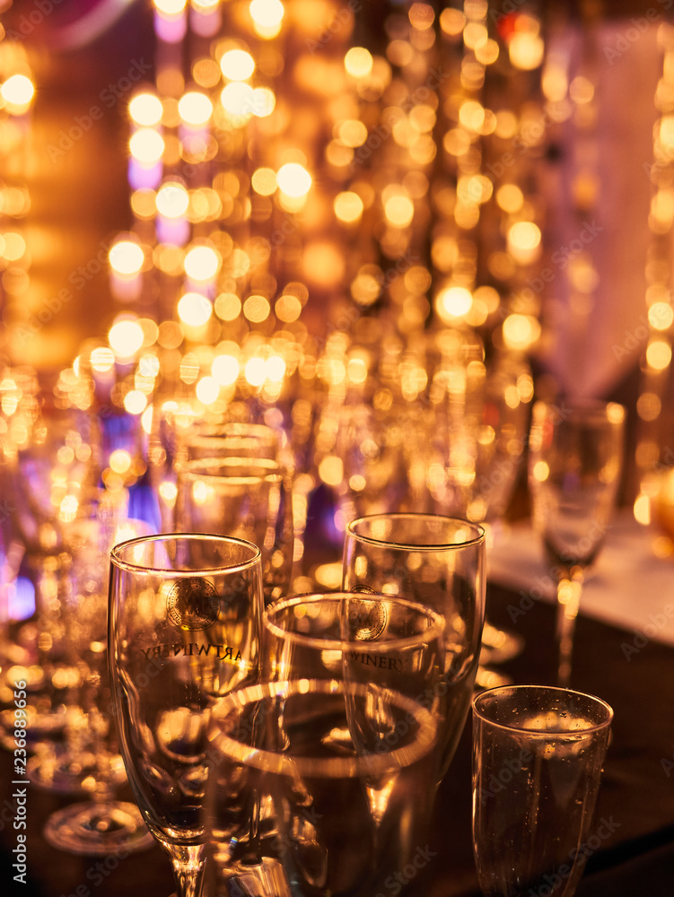 Xmas eve festive celebration blurry background with glasses of champagne. Vintage gold Fireworks and bokeh in New Year eve and copy space. holiday background Xmas eve festive celebration blurry background with glasses of champagne. Vintage gold Fireworks and bokeh in New Year eve and copy space. holiday background