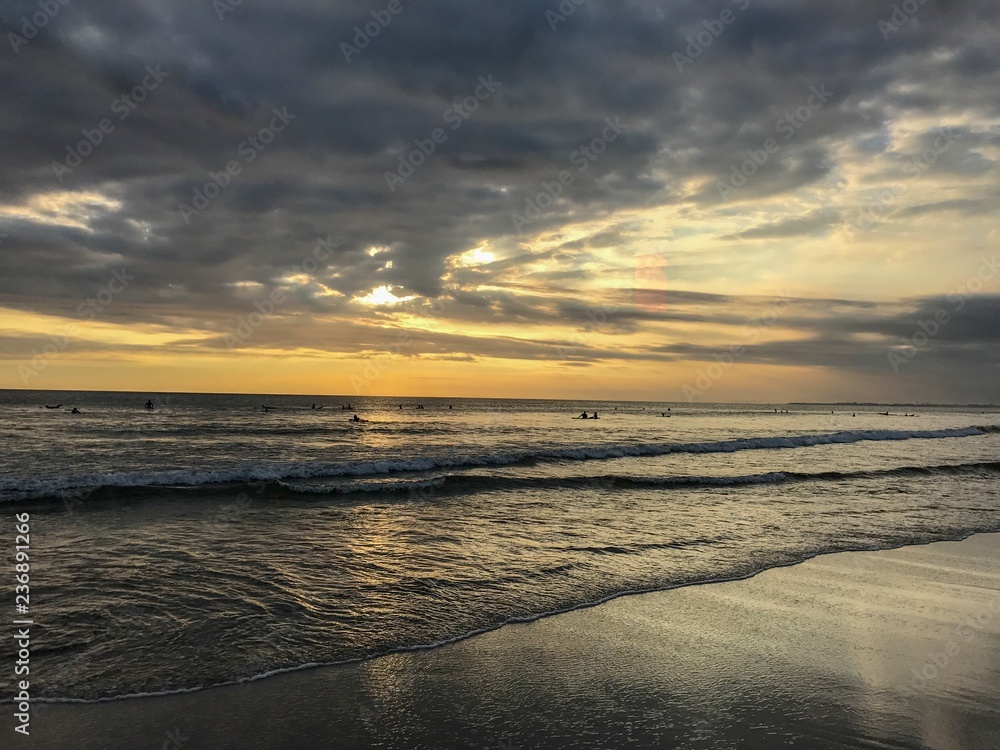 Sunset on the beach in Bali with cloudy sky