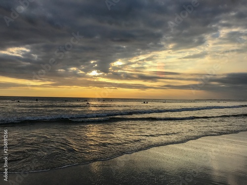 Sunset on the beach in Bali with cloudy sky