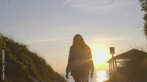Woman walks away from beach